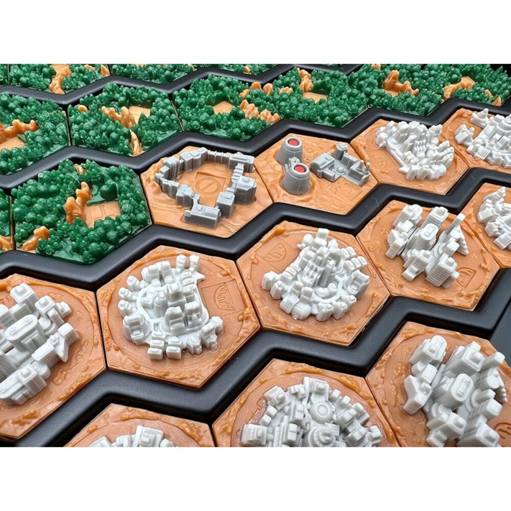 Close-up of the tiles in the Terraforming Mars: 3D Tiles box, with rows of city tiles in the front and forests in the back